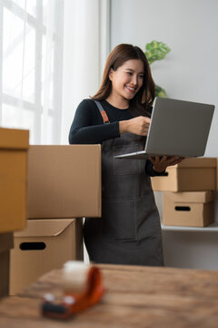 Young woman processing online orders for small business