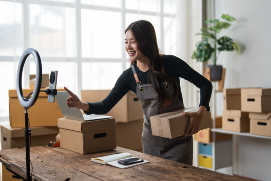 Woman recording livestream selling online products from home