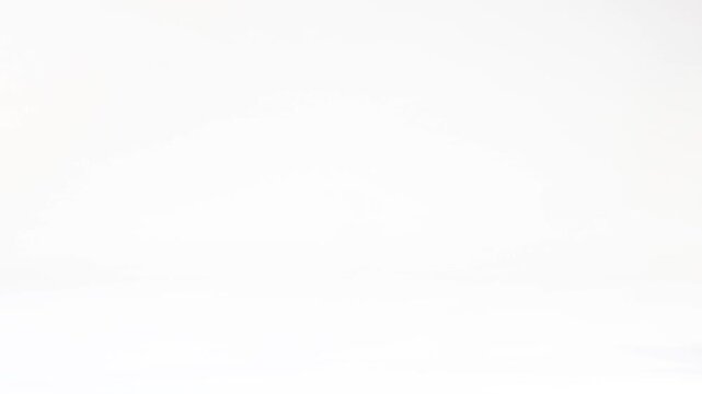 Bright Red Rubber Ball Bouncing Across a Plain White Background