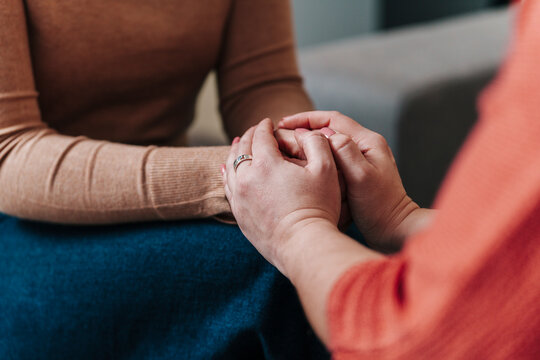 Supportive gesture with hands holding in an indoor coaching setting