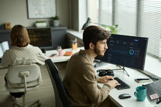 Employee analyzing corporate information at office table