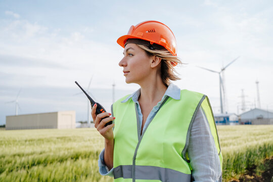 Engineer with safety helmet standing at field