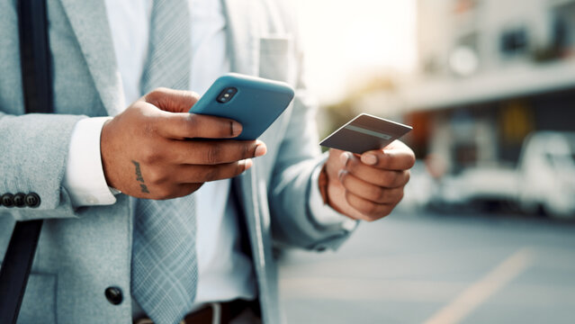 Businessman, hands and credit card with phone in city for online shopping or mobile banking app. Man, user or shopper with smartphone or debit for ecommerce, payment or wireless transaction in town