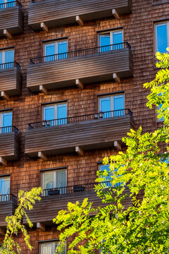 Modern urban scandinavia residential architecture built with sustainable wood and timber facade balconies highlighting daylight structure and design