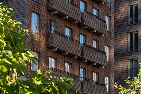 Sustainable urban scandinavia residential architecture combines modern wood timber balconies and facade with greenery for a calm daylight exterior