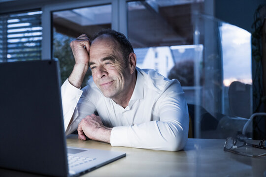 Freelancer having video call on laptop at home office