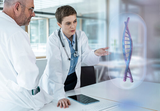 Medical team analyzing holographic DNA model in laboratory