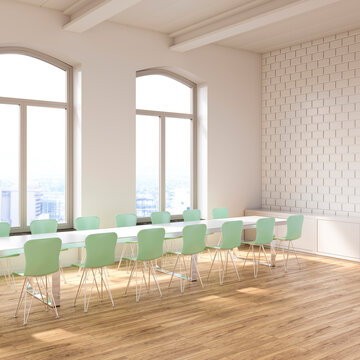 Modern empty conference room with green chairs and bright windows