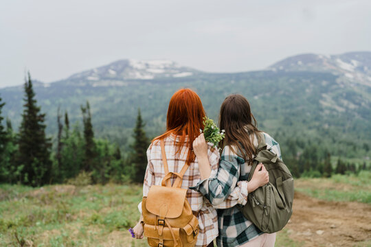 Tourist friends hugging outdoors at Mountain Zelenaya Sheregesh