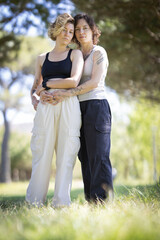 Fototapeta premium Loving lesbian couple embracing outdoors showing affection