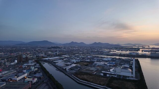 Marugame, Japan: Panoramic footage of dramatic sunset over coastal port and city of Marugame facing the Inland sea in Kagawa Prefecture in Japan