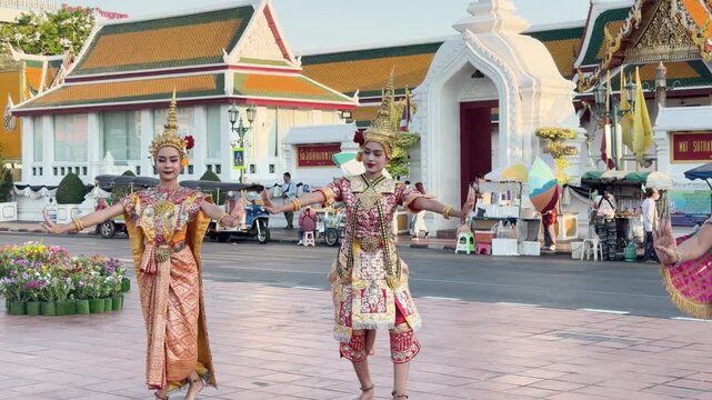 Traditional Thai Khon Dancers Performing in Front of Wat Suthat Temple