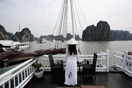 A person looking out at the limestone Karsts of Ha Long Bay, Vietnam.