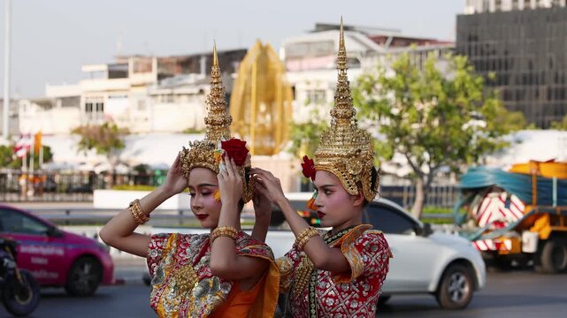 Thai Traditional Dancers Adjusting Golden Chada Headdresses in Bangkok