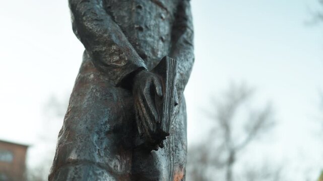A statue of the Russian writer Alexander Sergeyevich Pushkin standing on the street close-up.