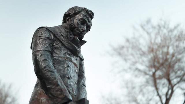 A statue of the Russian writer Alexander Sergeyevich Pushkin standing on the street close-up.