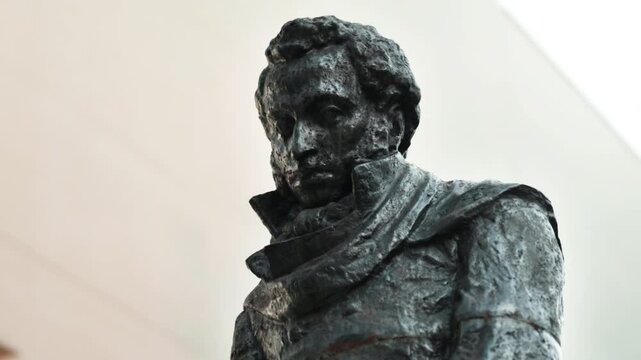 A statue of the Russian writer Alexander Sergeyevich Pushkin standing on the street close-up.