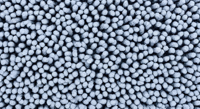 Close up of small spherical plastic pellets a textured background of polyethylene beads for industrial applications