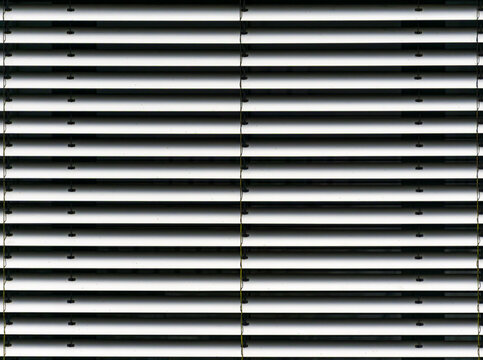 Metal louver slats forming geometric ventilation pattern