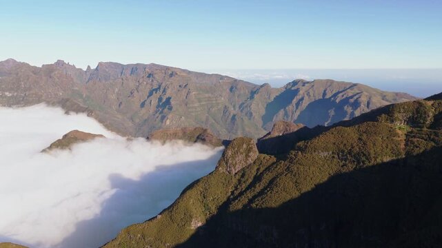 Aerial view of misty mountain valley in Madeira with cloud inversion