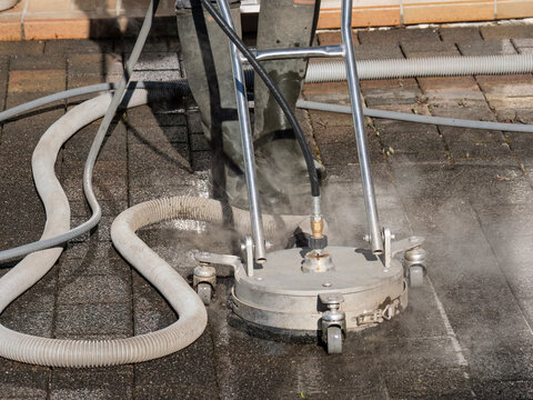Hot Water Pressure Washer Cleaning Stone Patio Surface