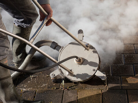Hot Water Pressure Washer Cleaning Stone Patio Surface
