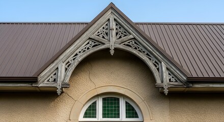 Obraz premium modern metal panels Renovation replaces old roof slope Gothic Revival gable featuring a weathered, hand-carved wooden bargeboard