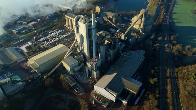 Aerial drone view of the massive Cemex cement production factory and chimney in Rugby UK.