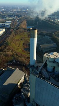 Straight down aerial view of the mechanical structures and storage silos at a major cement plant.
