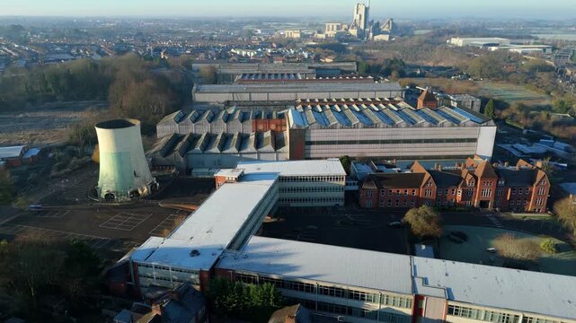 Aerial drone view of a massive industrial factory complex and manufacturing facility in Rugby UK.