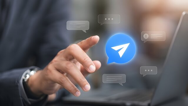Businessman touching blue send message bubble icon for digital communication
