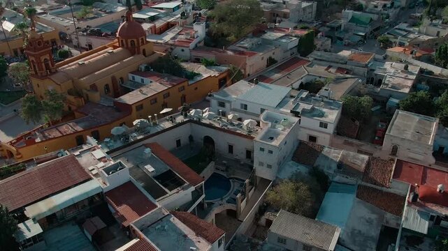 San Sebastian's Temple And Pe&ntilde;a de Bernal monolith towering over settlement in Quer&eacute;taro, Mexico