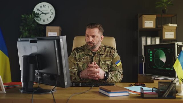 Portrait of Ukrainian army general working on computer in intelligence office