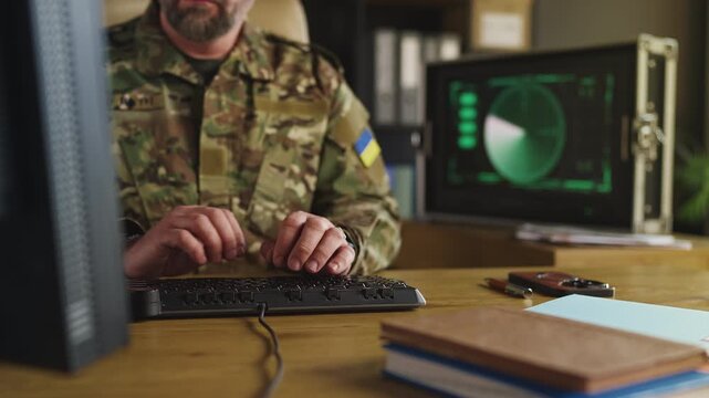 Ukrainian army officer managing national security planning on computer system