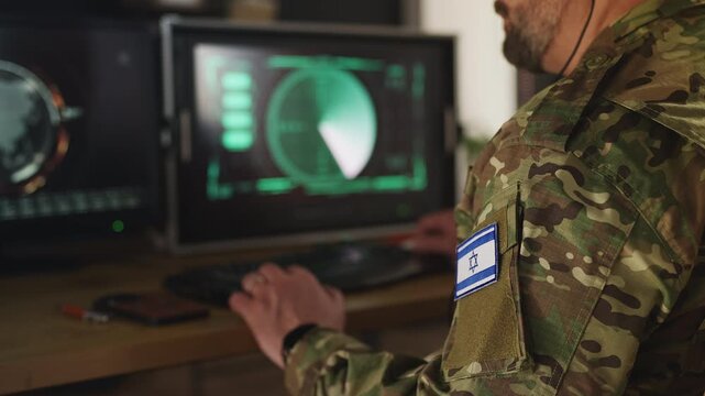 Israeli army officer assessing threats using monitoring systems
