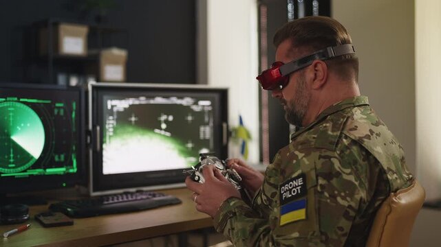 Ukrainian serviceman flying FPV drone carrying payload in command center