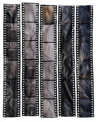 Obraz premium Printed 35mm slide film strips on paper, wrinkled and creased, arranged as abstract vintage design elements on a clean background.