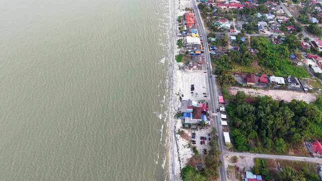 Aerial perspective captures coastal waters bordering beach