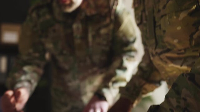 Military commanders planning intervention, discussing mission details over maps