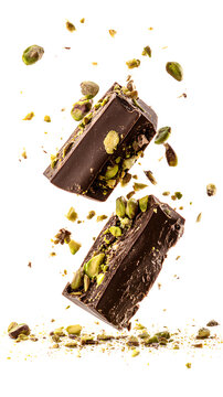 Broken Dubai chocolate in the air isolated on a white background. Dubai chocolate is made with pistachio paste and kadayif, isolated on a white background