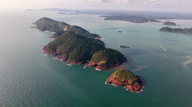 Aerial view of island chain rising from turquoise sea