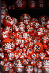 Fototapeta premium Red Daruma Dolls for Good Luck and Success – Traditional Japanese Lucky Charms Display
