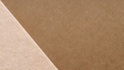 Brown and beige kraft paper layered on a diagonal for a minimal eco packaging background