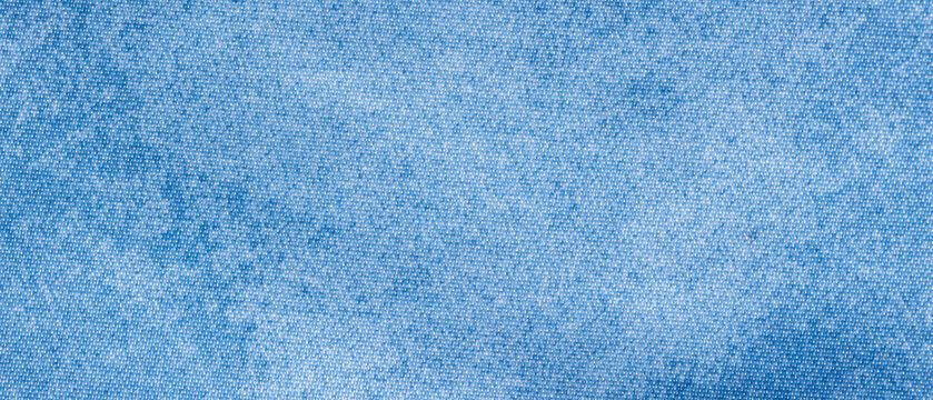 Washed light blue denim fabric texture background with faded cotton weave for casual apparel backdrop