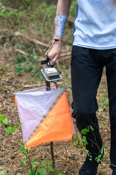 Close-up of an orienteer punching an electronic control