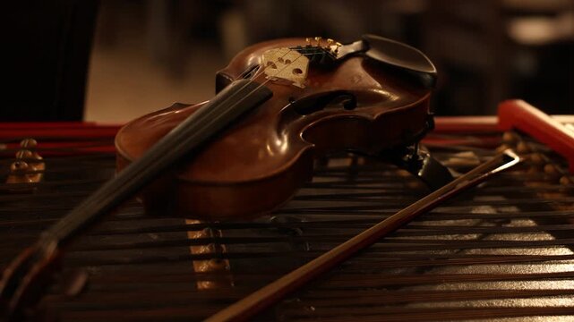 Violin resting on marimba bars, intimate studio still life