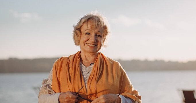 Woman smiling and enjoying at water's edge