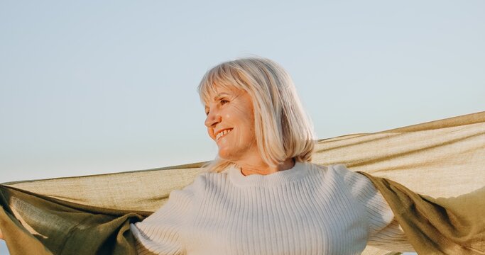 Senior woman smiling embracing freedom feeling happy
