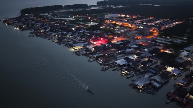 Aerial drone view of Kuala Gula fishing village at night