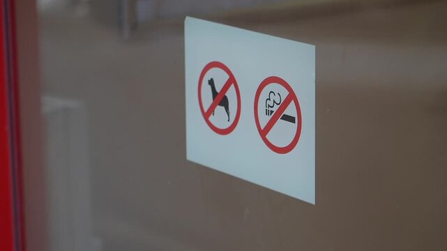 Signs showing rules for no dogs and no smoking